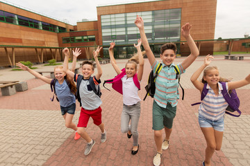 Fototapeta premium group of happy elementary school students running