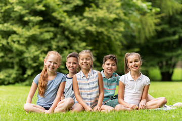 group of happy kids or friends outdoors