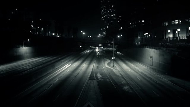 A surreal time lapse of traffic streaking across the freeway.