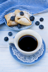 cup of coffee and cookies with blueberries