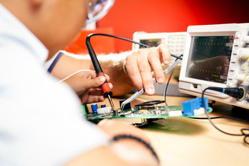 Little boy and teacher in class with electronic project