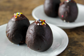 chocolate ball with topping on white plate