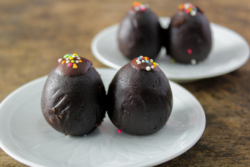 chocolate ball with topping on white plate