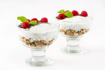 Chia yogurt with raspberries in a glass cup isolated

