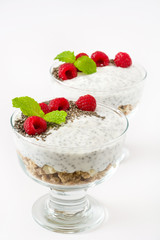 Chia yogurt with raspberries in a glass cup isolated


