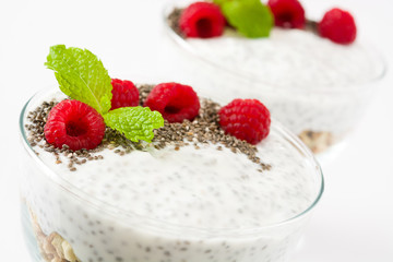 Chia yogurt with raspberries in a glass cup isolated

