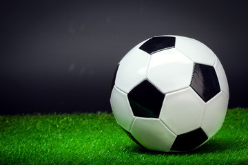 Naklejka na ściany i meble soccer ball on the green field