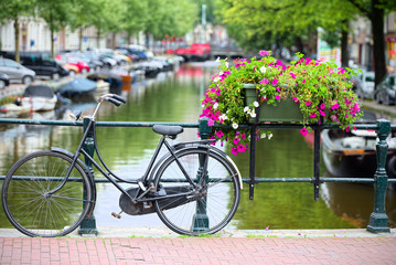 Fototapeta na wymiar Bicycle tied to a bridge in Amsterdam