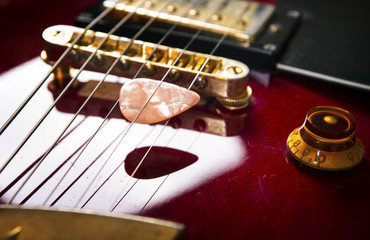 Obraz na płótnie Canvas Red acoustic guitar close up in dark background