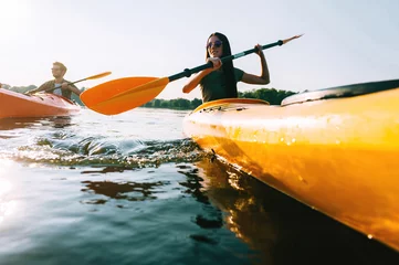 Foto op Canvas Couple kayaking. © gstockstudio