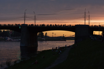 The bridge across the river against the sunset in the city