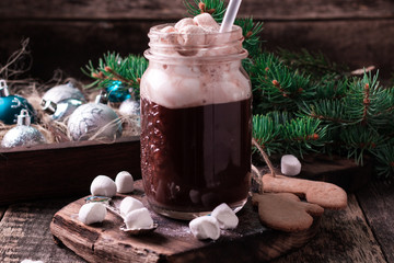 hot chocolate with marshmallows and cookies on black table, christmas concept