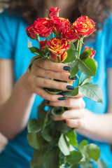 Bouquet of roses with long stems in female hands