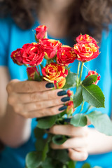 Bouquet of roses with stems in female hands