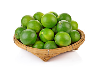 A basket of limes on white background