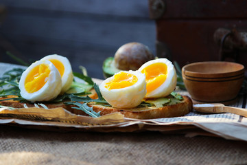 Toast with egg avocado and arugula