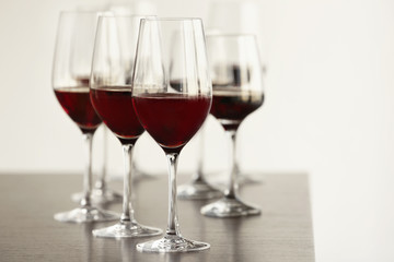 Glasses with red wine in a row on a table