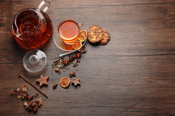 Ingredients for tea drinking on wooden background, flat lay
