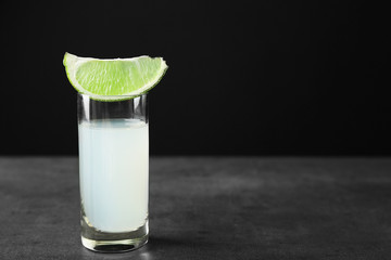 Shot with lime piece on gray table