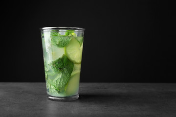 Delicious mojito with mint and lime slices on gray table