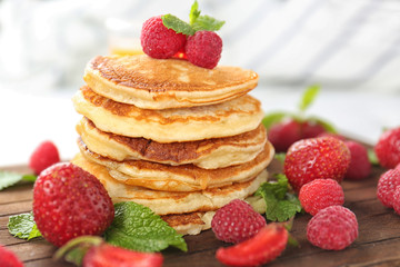 Tasty pancakes with berries and mint, closeup