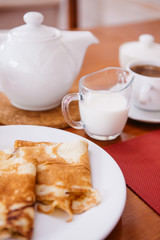 The breakfast in the Russian style: Russian pancakes, tea, cream