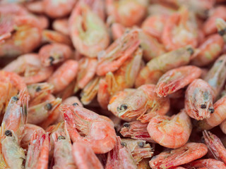 Frozen shrimps background on fish market, view from top
