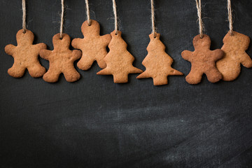 Christmas wooden background with fir tree,Gingerbread Cookies and holiday decor
