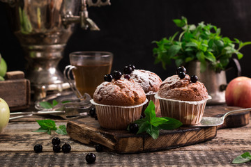 Blueberry muffins with powdered sugar and fresh berries