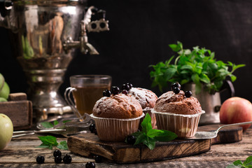 Blueberry muffins with powdered sugar and fresh berries