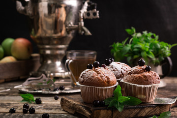 Blueberry muffins with powdered sugar and fresh berries