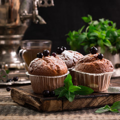 Blueberry muffins with powdered sugar and fresh berries