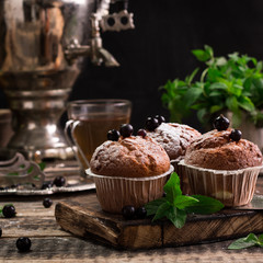 Blueberry muffins with powdered sugar and fresh berries