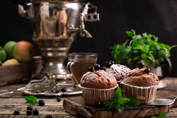 Blueberry muffins with powdered sugar and fresh berries
