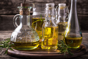 Oils on vintage wooden background . healthy food