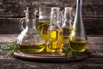 Oils on vintage wooden background . healthy food