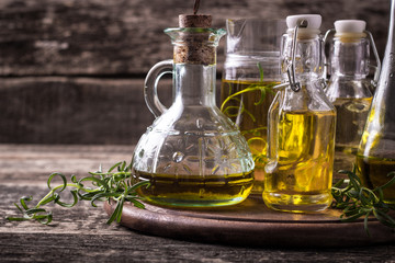 Oils on vintage wooden background . healthy food
