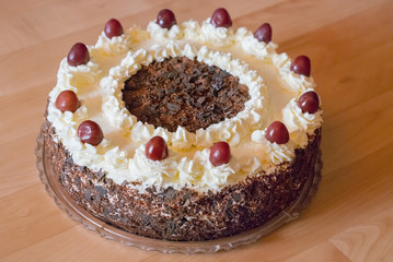 Dark Chocolate cake with white cream topping and cherries