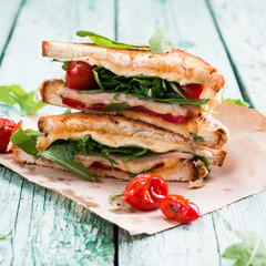 Sandwich bread, tomato, lettuce,ham, and yellow cheese