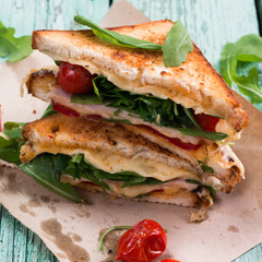 Sandwich bread, tomato, lettuce,ham, and yellow cheese
