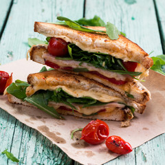 Sandwich bread, tomato, lettuce,ham, and yellow cheese