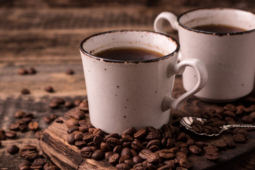 coffee cup with roasted  beans on wooden background