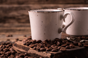 coffee cup with roasted  beans on wooden background