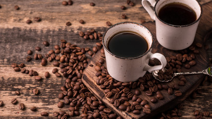 coffee cup with roasted  beans on wooden background