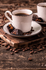 coffee cup with roasted  beans on wooden background