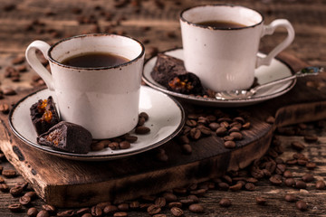 coffee cup with roasted  beans on wooden background