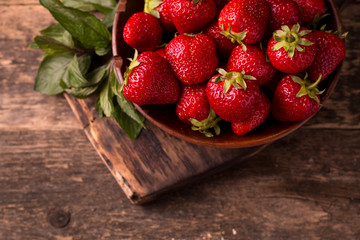 Ripe red strawberries on vintage wooden table