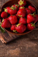 Ripe red strawberries on vintage wooden table