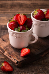 Ripe red strawberries on vintage wooden table