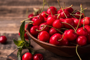  Ripe Cherries on wooden table with water drops
